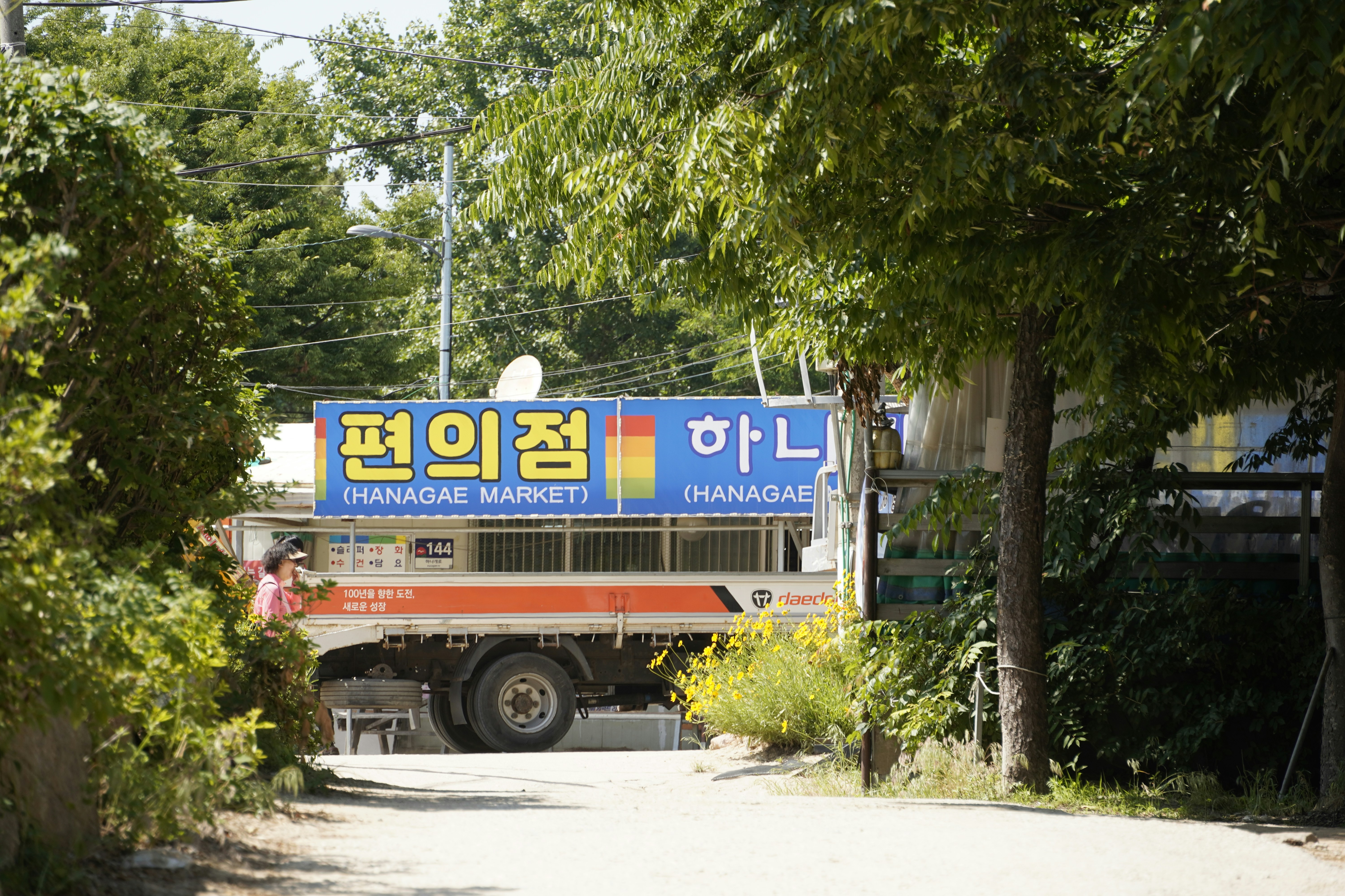 A large truck driving down a dirt road